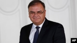 FILE - Member of Bosnia's newly elected tripartite presidency, Serb member, Mladen Ivanic, poses for a photograph during the presidency inauguration ceremony in Sarajevo, Bosnia, Nov. 17, 2014.