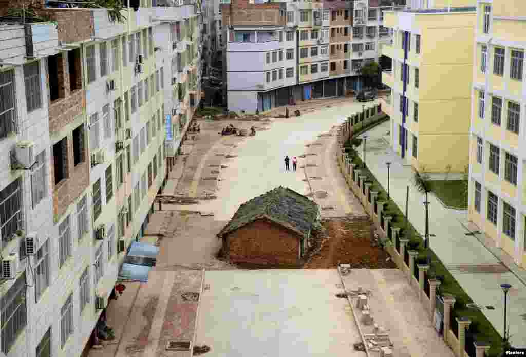 A &quot;nail house&quot;, the last building in the area, sits in the middle of a road under construction in Nanning, Guangxi Zhuang Autonomous Region, China. According to local media, the owner of the house didn&#39;t reach an agreement with the local authority about compensation of the demolition.