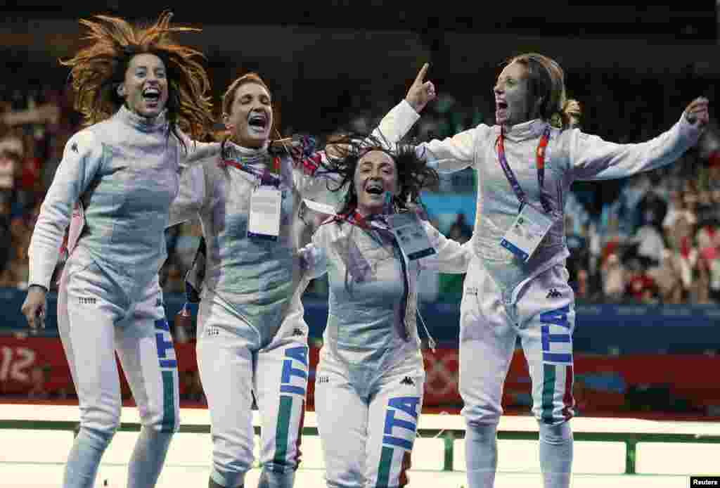 Members of Italy's fencing team celebrate after winning against Russia in their women's foil team gold medal match at the ExCel venue during the London 2012 Olympic Games, August 2, 2012.