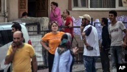 People stand on the streets after evacuating their homes, following an earthquake in Istanbul, Sept. 26, 2019. Turkey's emergency authority says a 5.8 magnitude earthquake has shaken Istanbul with no immediate damage reported.