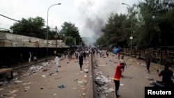 Smoke rises as supporters of Imam Mahmoud Dicko and other opposition politicians protest after President Ibrahim Boubacar Keita rejected concessions, aimed at resolving a monthslong political standoff, in Bamako, Mali, July 10, 2020.