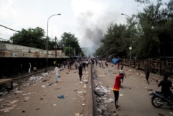 Smoke rises as supporters of Imam Mahmoud Dicko and other opposition politicians protest after President Ibrahim Boubacar Keita rejected concessions aimed at resolving a monthslong political standoff, in Bamako, Mali, July 10, 2020.