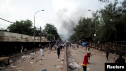 FILE - Smoke rises as supporters of Imam Mahmoud Dicko and other opposition political parties protest after President Ibrahim Boubacar Keita rejected concessions, aimed at resolving a months-long political stand-off, in Bamako, Mali, July 10, 2020.