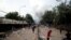 FILE - Smoke rises as supporters of Imam Mahmoud Dicko and other opposition political parties protest after President Ibrahim Boubacar Keita rejected concessions, aimed at resolving a months-long political stand-off, in Bamako, Mali, July 10, 2020.