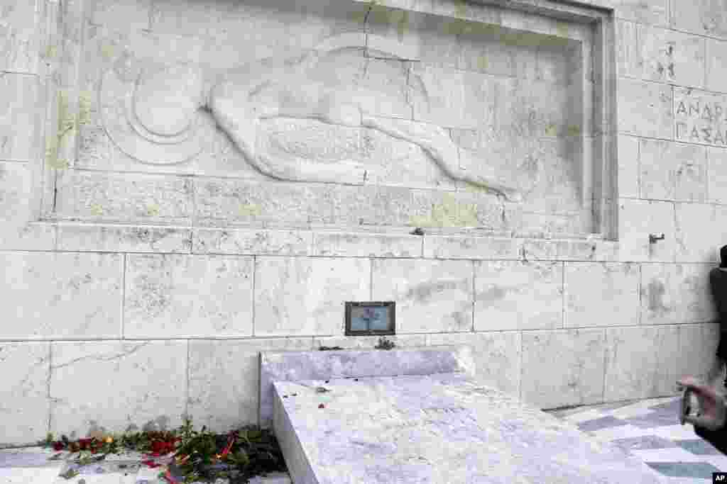 A wreath laid earlier by visiting German Chancellor Angela Merkel&nbsp;at the Tomb of the Unknown Soldier in Athens lies on the ground after being destroyed by protesting state schoolteachers in Greece.