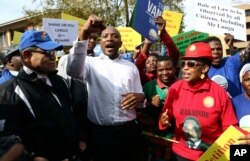 FILE - South Africa's opposition Democratic Alliance party leader, Mmusi Maimane, center, protests with fellow supporters of Zambia's jailed opposition leader Hakainde Hichilema outside the High Commission of Zambia in Pretoria, South Africa, May 26, 2017.