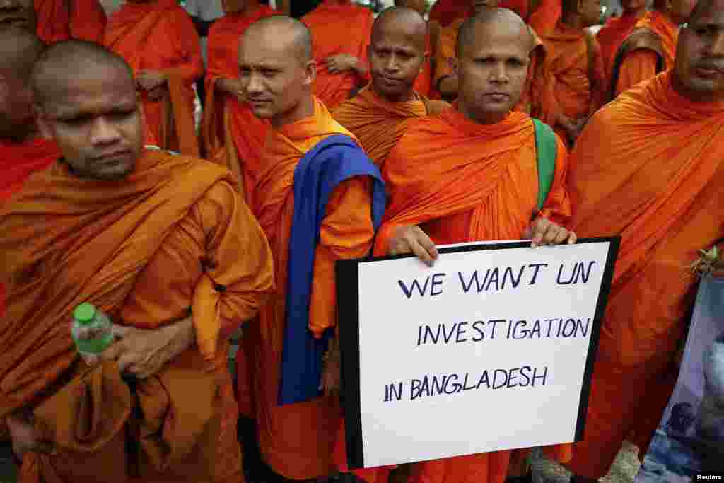 Buddhist monks hold a placard as they protest in front of the U.N. office in Bangkok, Thailand, October 3, 2012. 