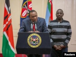 Kenya's President Uhuru Kenyatta flanked by his deputy, William Ruto, addresses the nation at State House in Nairobi, Kenya, Sept. 1, 2017.