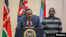 Kenya's President Uhuru Kenyatta flanked by his deputy, William Ruto, addresses the nation at State House in Nairobi, Kenya, Sept. 1, 2017.