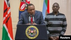 Kenya's President Uhuru Kenyatta flanked by his deputy, William Ruto, addresses the nation at State House in Nairobi, Kenya, Sept. 1, 2017.