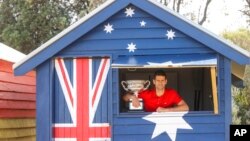 FILE - Serbia's Novak Djokovic poses with Norman Brookes Challenge Cup the day after after defeating Russia's Daniil Medvedev in the men's singles final at the Australian Open tennis championship in Melbourne, Australia, Feb. 22, 2021. 