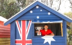 FILE - Serbia's Novak Djokovic poses with Norman Brookes Challenge Cup the day after after defeating Russia's Daniil Medvedev in the men's singles final at the Australian Open tennis championship in Melbourne, Australia, Feb. 22, 2021.