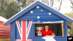 FILE - Serbia's Novak Djokovic poses with Norman Brookes Challenge Cup the day after after defeating Russia's Daniil Medvedev in the men's singles final at the Australian Open tennis championship in Melbourne, Australia, Feb. 22, 2021. 