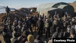 Troops gather around Prime Minister Benjamin Netanyahu as he visits a recently occupied position on the summit of Mount Hermon, inside a Syrian buffer zone of the Golan Heights, Dec. 17, 2024. (Maayan Toaf/Israeli Government Press Office)