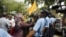 Supporters of former Maldives President Mohammed Nasheed gesture to police officers after the commission of national inquiry released its report in Male, Maldives, August 30, 2012.
