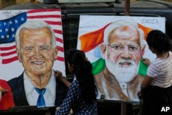 FILE - Students of Gurukul school of Art draw portraits of U.S. President Joe Biden and Prime Minister of India Narendra Modi ahead of the upcoming G20 summit, in Mumbai, India, Tuesday, Sept. 5, 2023