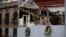 Funeral wreaths stand in front of the lot where a chemical laboratory collapsed, heavily damaging two adjacent buildings, in the Roma Norte area of Mexico City, Oct. 1, 2017.