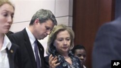 Secretary of State Hillary Rodham Clinton departs Capitol Hill in Washington, March 30, 2011, after leading a closed-door briefing on Libya for members of the House of Representatives.