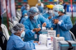 A nurse prepares a dose of the vaccine developed by Sinopharm of China against COVID-19 during a health workers vaccination campaign amid the novel coronavirus pandemic, in Ate, a district in Lima, on February 19, 2021.