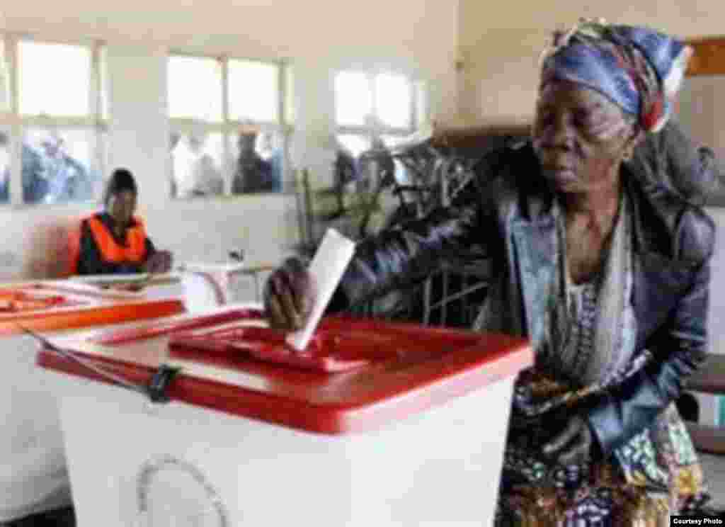 A woman votes in Zambia