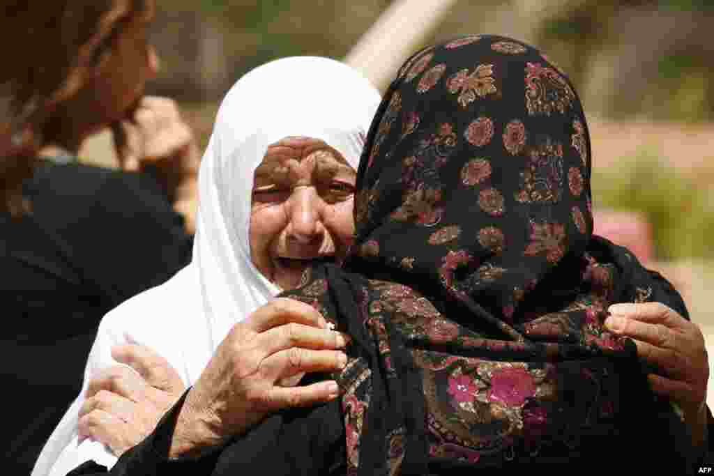 Relatives of Lebanese passenger Mohamed Akhdar, 23, who was aboard the Air Algerie plane that crashed over Mali on Thursday, mourn at the family&#39;s home in the village of Zrairiyeh in south Lebanon.