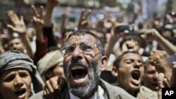 Anti-government protesters shout slogans during a demonstration demanding the resignation of Yemeni President Ali Abdullah Saleh, in Sana'a, Yemen, March 23, 2011