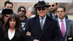 Roger Stone accompanied by his wife Nydia Stone, left, arrives for his sentencing at U.S. District Court in Washington, Feb. 20, 2020. 