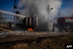 Petugas pemadam kebakaran Kurdi Suriah memadamkan api di pembangkit listrik di Qamishli yang dilaporkan menjadi sasaran drone Turki pada 15 Januari 2024. (Foto: AFP)