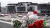 Flowers and toys left at the side of a road near the burnt-out Crocus City Hall concert venue in Krasnogorsk, outside Moscow, on March 26, 2024. (Natalia Kolesnikova/AFP)