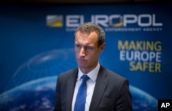 FILE - The head of the European police agency Europol, Rob Wainwright answers questions at The Hague, Netherlands, Jan. 16, 2015.