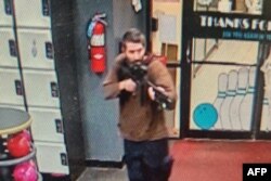 FILE - This handout image released on October 25, 2023 by the Androscoggin County Sheriff's Office via Facebook shows a photo of the armed suspect in a shooting in Lewiston, Maine.