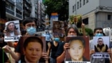 Pro-democracy demonstrators hold up portraits of jailed Chinese civil rights activists, lawyers and legal activists as they march to the Chinese liaison office in Hong Kong, Thursday, June 25, 2020. They demand to abolish the national security law…