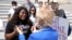 Rep. Cori Bush, D-Mo., left, greets Sen. Elizabeth Warren, D-Mass., after Warren arrived to support Bush, who spent the night at the U.S. Capitol to highlight the coming expiration of a pandemic-related federal moratorium on evictions, July 31, 2021.