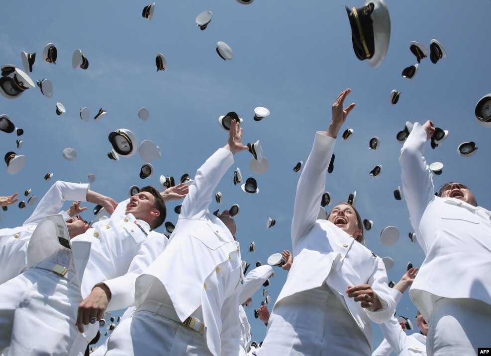 U.S. Naval Academy graduates toss their hats in the air during graduation ceremonies at the U.S. Naval Academy in Annapolis, Maryland.