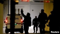 Police officers investigate after five people were killed and others injured by a man using a bow and arrows to carry out attacks, in Kongsberg, Norway, Oct. 13, 2021. 
