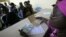FILE - Town hall workers in Ivory Coast's main city, Abidjan, check through paperwork as people born in the West African state apply for birth certificates.