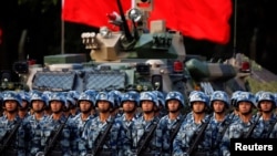 FILE - Troops prepare for the arrival of Chinese President Xi Jinping, June 30, 2017, at the People's Liberation Army Hong Kong Garrison in Hong Kong.