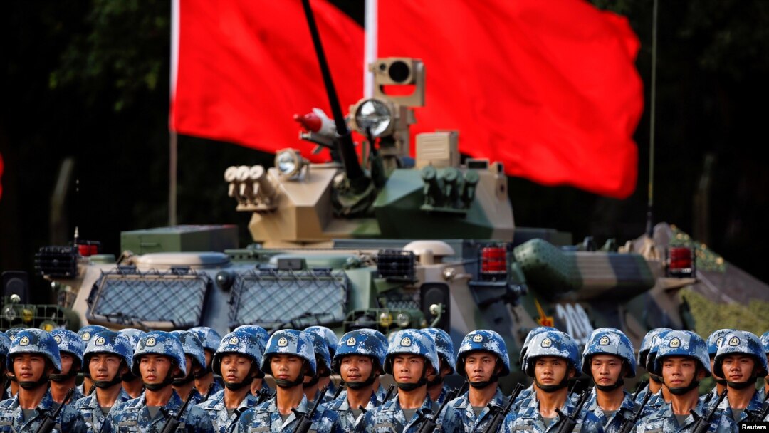 FILE - Troops prepare for the arrival of Chinese President Xi Jinping, June 30, 2017, at the People's Liberation Army Hong Kong Garrison in Hong Kong.