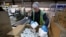 FILE: Worker fills a box with toilet paper at the Tissue Plus factory, Wednesday, March 18, 2020, in Bangor, Maine. 