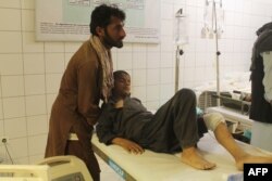FILE - An Afghan boy is treated at a hospital following an airstrike in Kunduz province, northern Afghanistan, April 2, 2018.