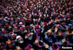 FILE - School girls wearing pink turban wave during celebrations to mark International Day of the Girl Child 2018, at a school in Chandigarh, India October 11, 2018.