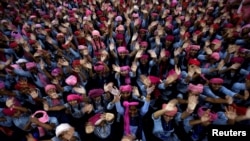 School girls wearing pink turban wave during celebrations to mark International Day of the Girl Child 2018, at a school in Chandigarh, India October 11, 2018. 