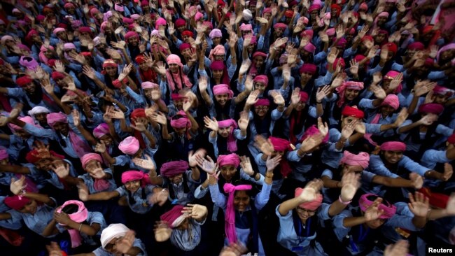 School girls wearing pink turban, a head covering, wave during celebrations of International Day of the Girl Child 2018, at a school in Chandigarh, India October 11, 2018. (REUTERS/Ajay Verma)