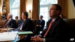 FILE - White House Chief of Staff Mick Mulvaney listens as President Donald Trump speaks during a cabinet meeting at the White House, Jan. 2, 2019, in Washington.