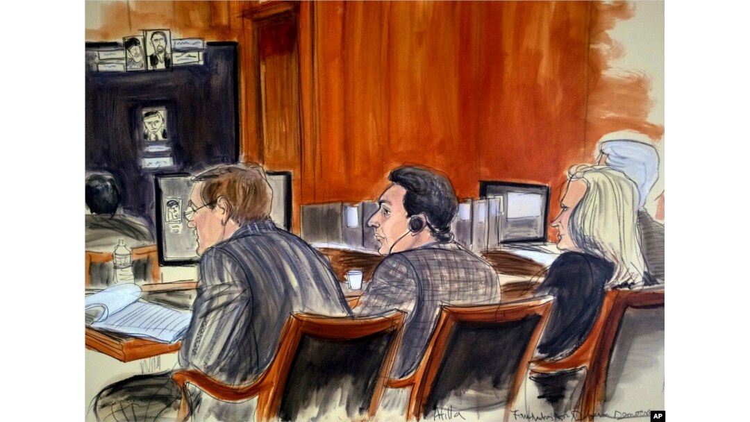 In this courtroom sketch, defendant Mehmet Hakan Atilla, center, listens to proceedings from the defense table, Nov. 28, 2017, in New York. Prosecutors claim that Atilla laundered Iranian oil money in violation of U.S. economic sanctions.