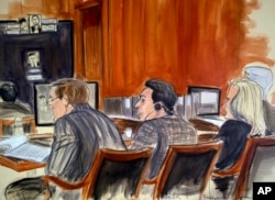 In this courtroom sketch, defendant Mehmet Hakan Atilla, center, listens to proceedings from the defense table, Nov. 28, 2017, in New York. Prosecutors claim that Atilla laundered Iranian oil money in violation of U.S. economic sanctions.