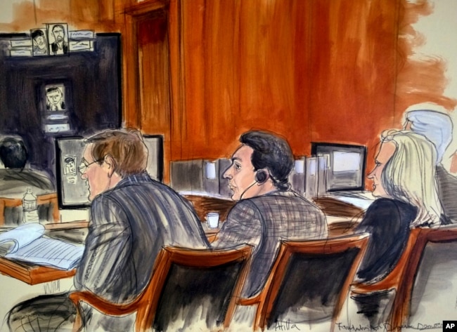 In this courtroom sketch, defendant Mehmet Hakan Atilla, center, listens to proceedings from the defense table, Nov. 28, 2017, in New York. Prosecutors claim that Atilla laundered Iranian oil money in violation of U.S. economic sanctions.