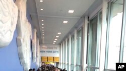 In this photo provided by Twitter user Ninis Samuel, travelers stand in long lines to clear customs at John F. Kennedy International Airport, Aug. 16, 2019, in New York, because of a temporary computer outage.