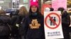女权五姊妹之一大兔(郑楚然)身著自营的淘宝店女权主义带帽卫衣，倡导反性骚扰。 (郑楚然提供)