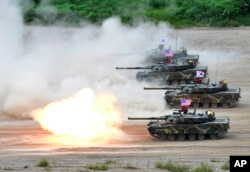 In this photo provided by the South Korean Defense Ministry, a South Korean marine K1 tank fires during a joint military exercise between South Korea and the United States in Pohang, South Korea, July 6, 2016.